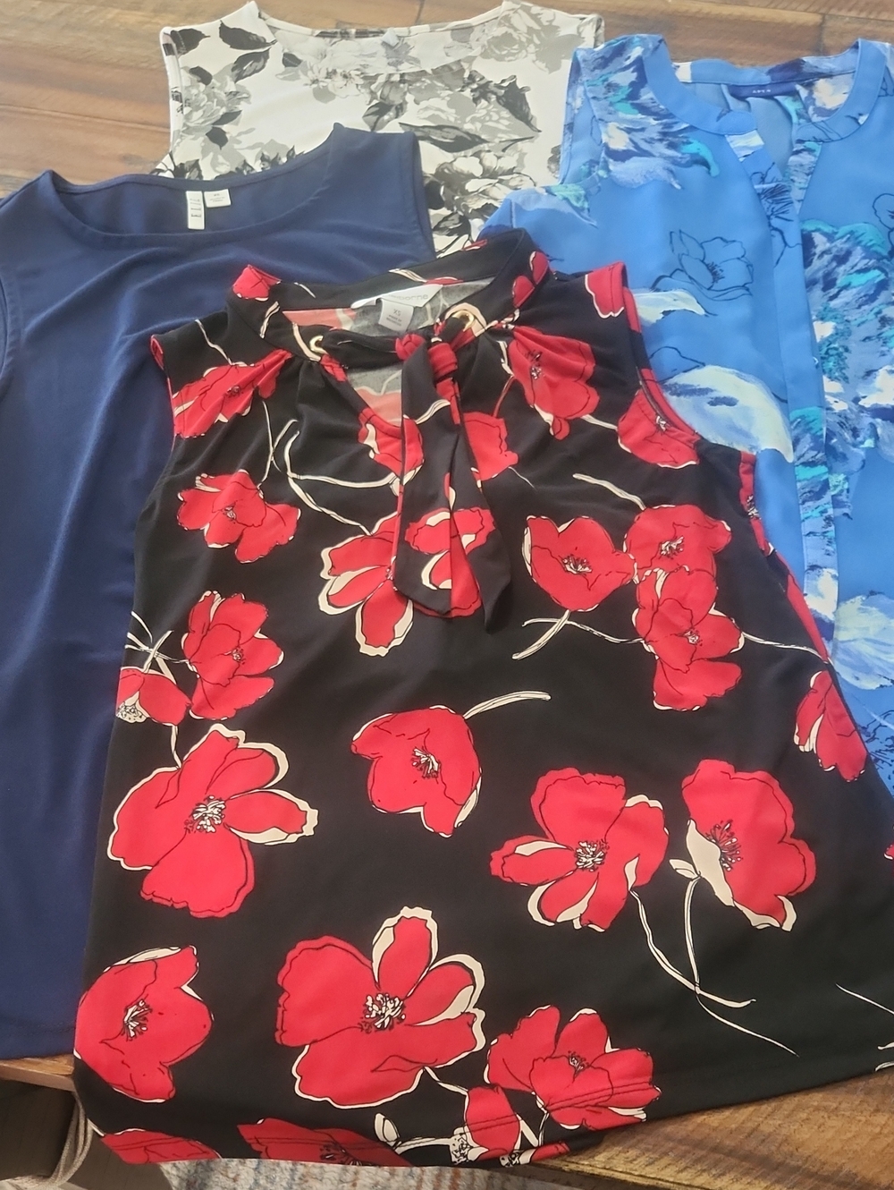 4 Size small sleeveless blouses.